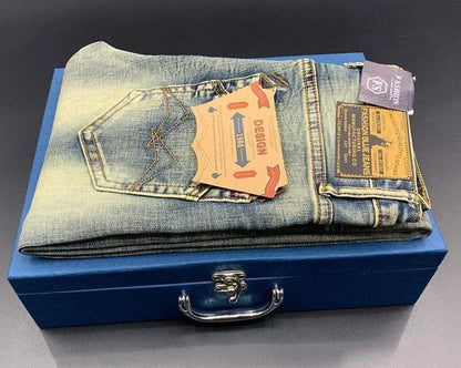 Light blue wash, stretchy tapered jeans with gold stitching on a blue box for daily casual wear.