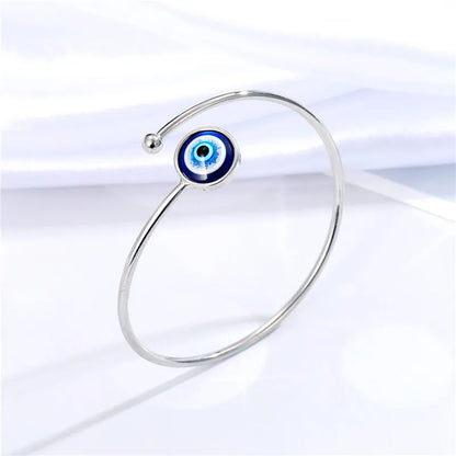 Adjustable cuff bracelet with a geometric evil eye motif