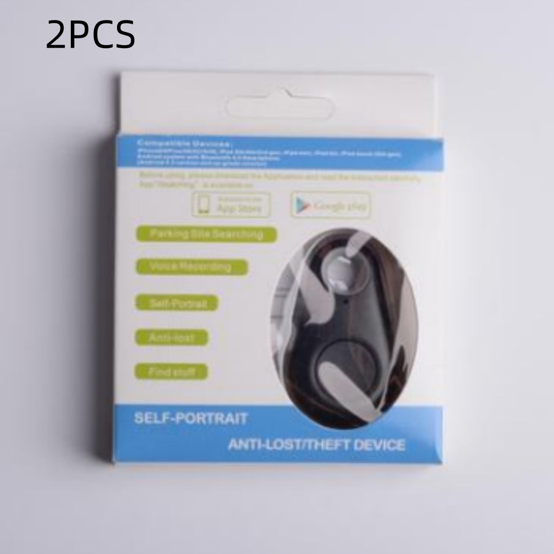 Black, oval waterproof Bluetooth tracker in white retail packaging to secure keys and bags.
