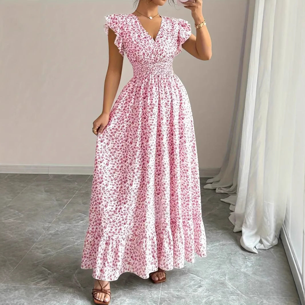Pink floral polyester flowy dress with ruffled sleeves and a fitted waist for resortwear.