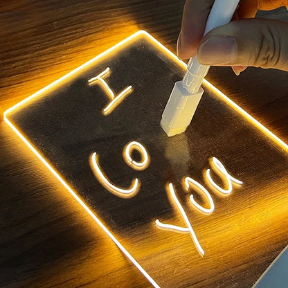 Hand writing on glowing acrylic message board with white marker