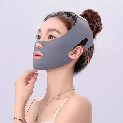 Woman wearing a gray jawline contour strap covering her chin and cheeks with cutouts for mouth and nose.