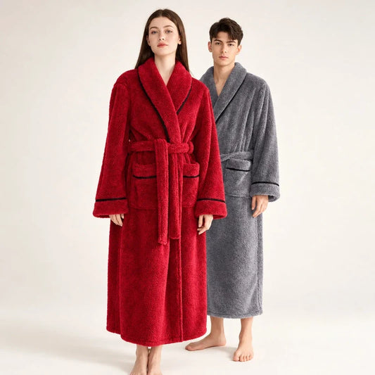 A woman and a man wearing matching plush winter bathrobes in red and grey.