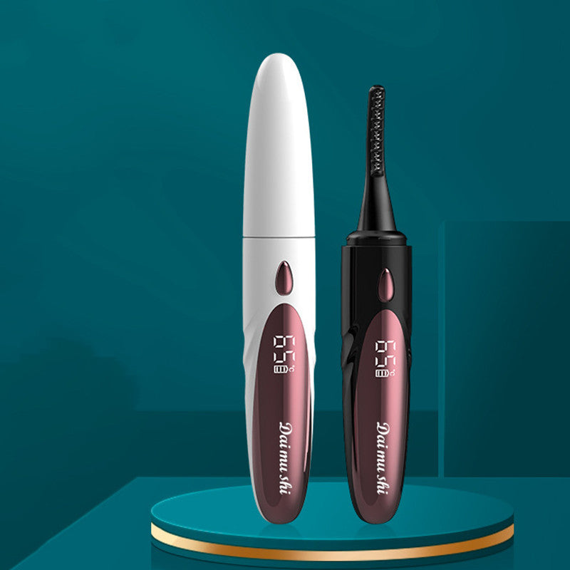 White and black heated eyelash curlers standing upright with digital temperature displays.