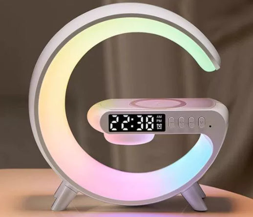 White G-shaped LED lamp with wireless charger, digital clock, and Bluetooth speaker for bedside light and charging.