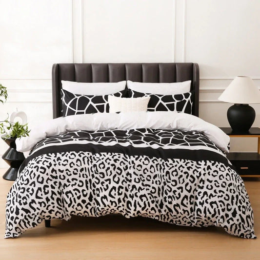 Bedding set with black and white giraffe and leopard print duvet cover and pillow shams on a bed