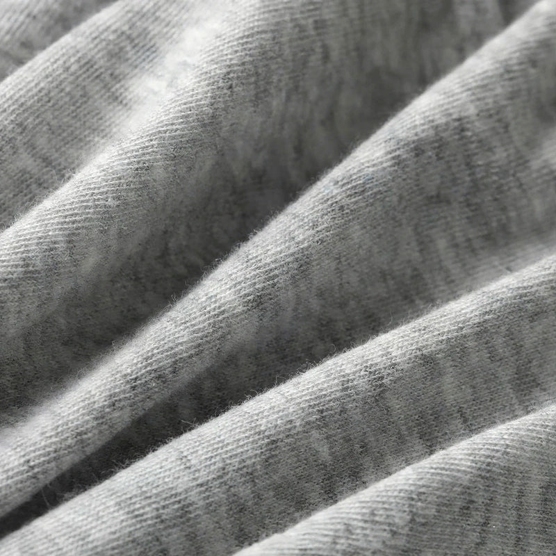 Close-up of soft grey cotton knit fabric with visible folds