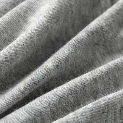 Close-up of soft grey cotton knit fabric with visible folds