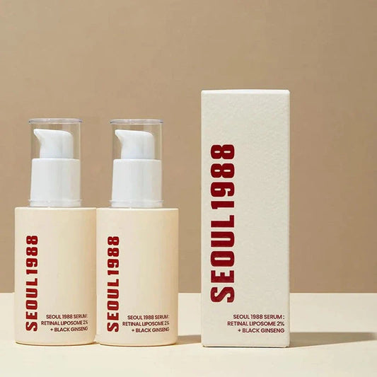 Two cream-colored facial serum bottles with white pump tops and red text, alongside a matching product box.