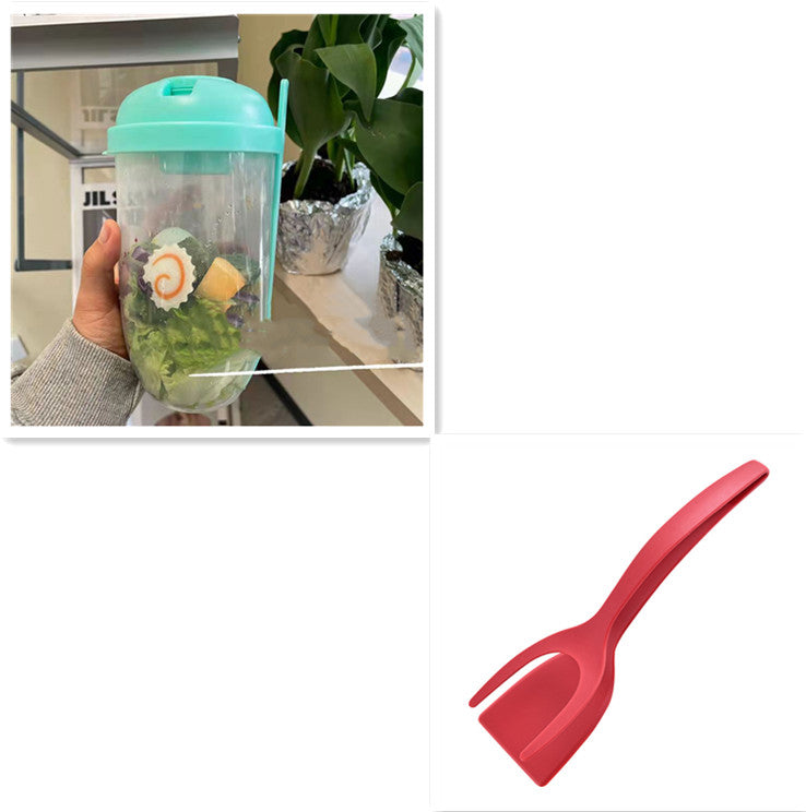 Hand holding clear salad cup with mint green lid and contents inside