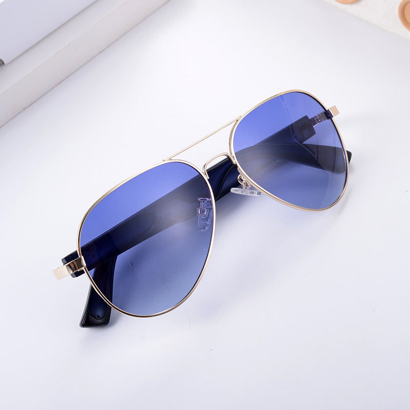 Gold-frame aviator smart wearables with blue polarized lenses for real-time translation during travel and outdoor use.