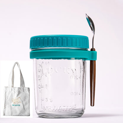 Glass overnight oats jar with teal lid, silicone band, spoon, and small tote bag