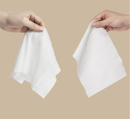 Pet grooming wipes shown with textured fabric being held up by two hands