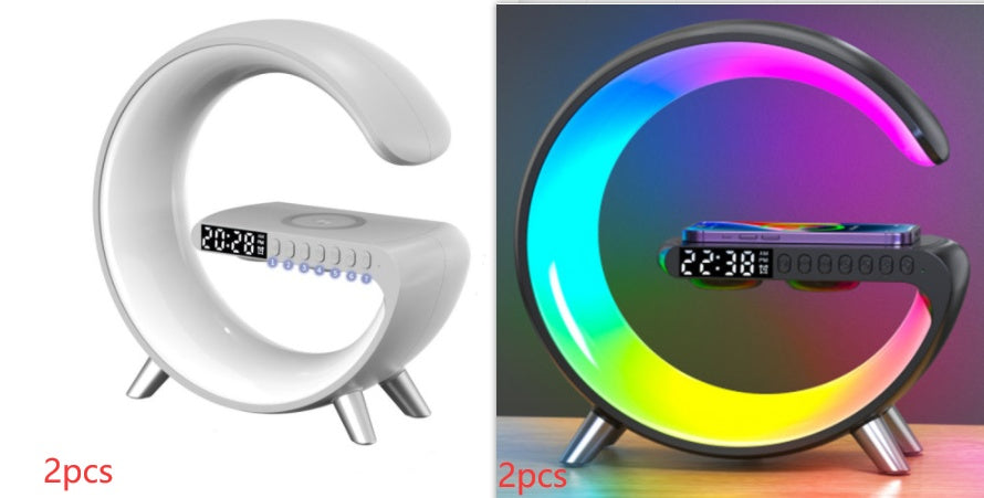 G-shaped white and black LED lamp with wireless charger and Bluetooth speaker for bedside desks.