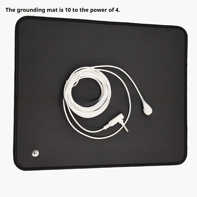 Grounding mat with coiled grounding cord snap connector and plug
