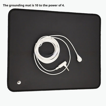 Grounding mat with coiled grounding cord snap connector and plug