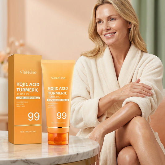 Kojic acid turmeric body cream tube and box next to smiling woman in robe