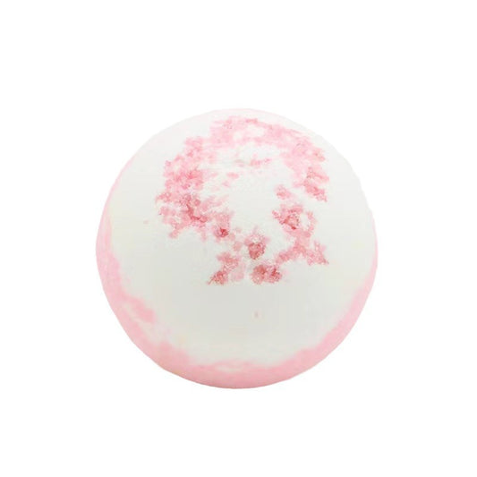 Round white bath bomb with pink speckles and bottom blush