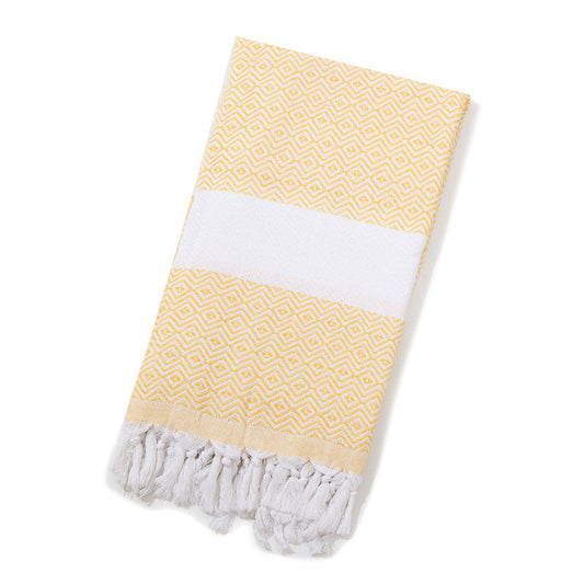 Folded yellow and white patterned towel with a solid white stripe and fringed ends.