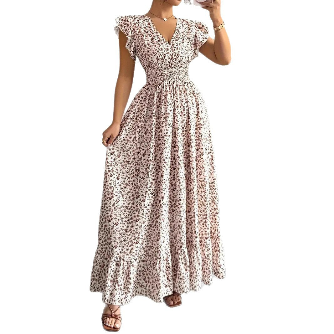 White polyester floral dress with a flowy skirt, v-neck, and flutter sleeves for resortwear.