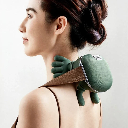 A woman wearing a green cordless neck massager with simulated hands massaging her neck and shoulders.