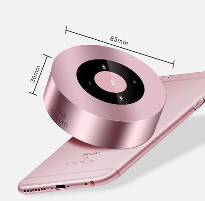 Round pink wireless speaker showing 85mm and 30mm dimension measurements above a pink smartphone.