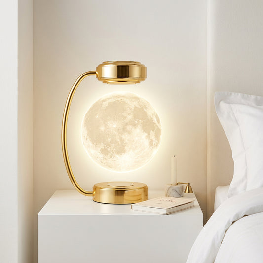 Levitating moon lamp in gold frame glowing on a bedside table
