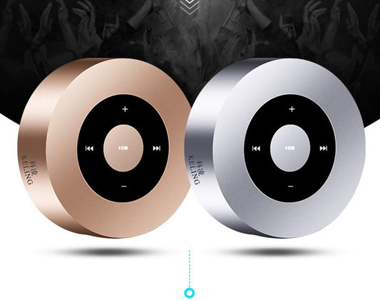 Two round portable Bluetooth speakers in gold and silver with black control panels.