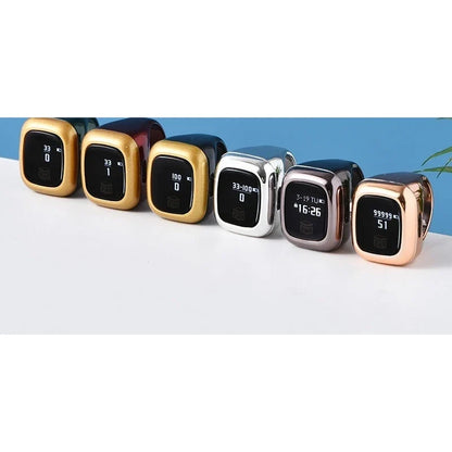 Six digital tasbih counter rings in various metallic finishes with small screens arranged in a row.
