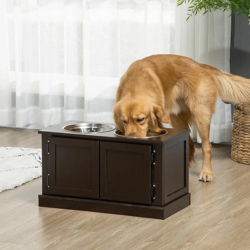Golden retriever eating from a dark brown wooden raised double dog feeder station with two metal bowls.