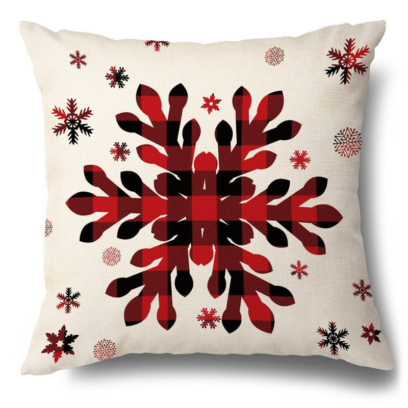 Square throw pillow cover with a red and black buffalo plaid snowflake design surrounded by smaller snowflakes.