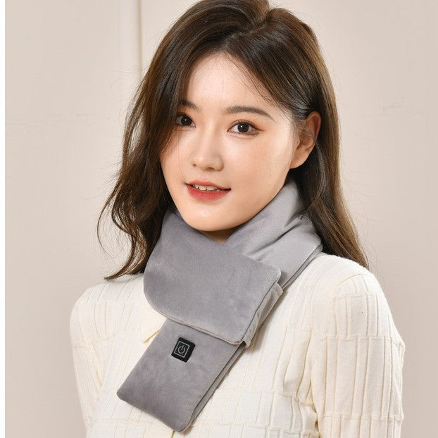 A woman wearing a soft grey heated scarf with a power button control panel.