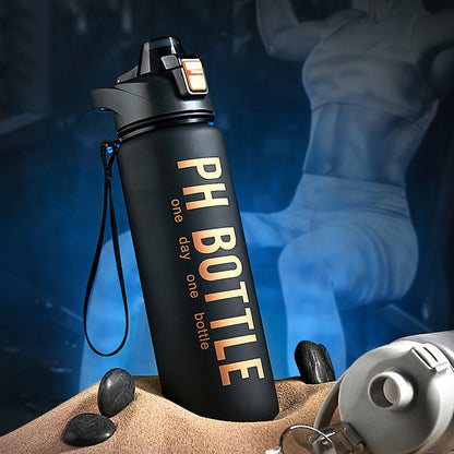 Direct-drink water bottle with flip cap and carry strap in a gym setting