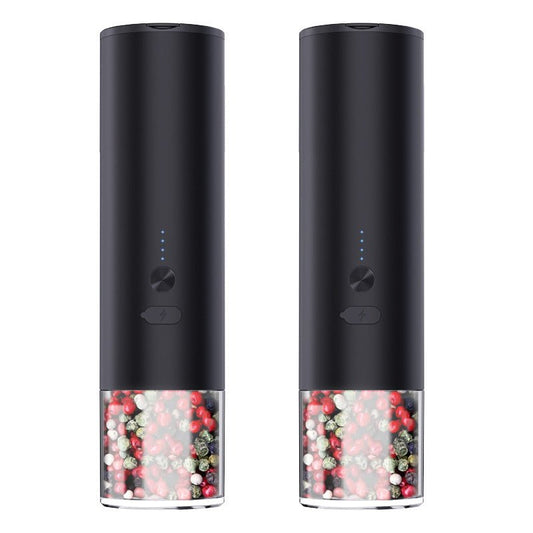 Two black electric grinders with clear lower chambers filled with colorful peppercorns and front power buttons.