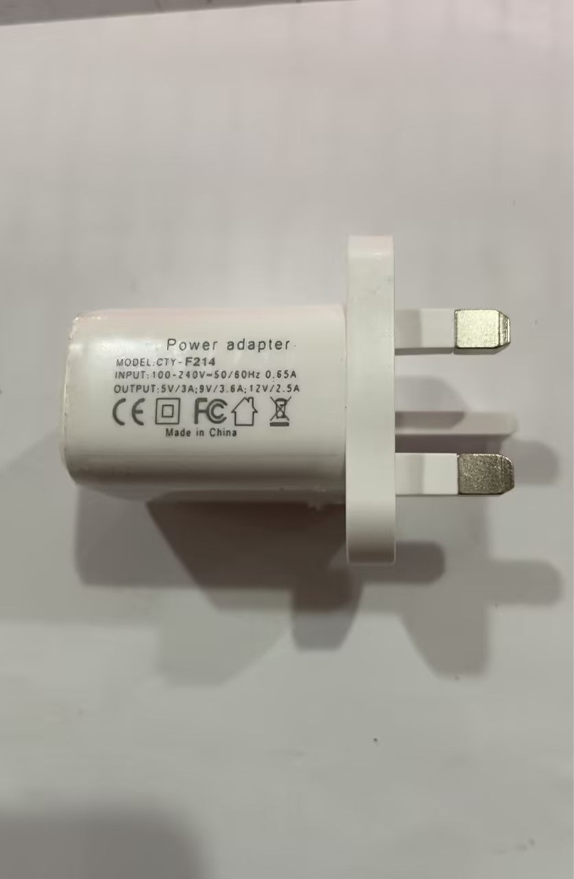 White plastic UK power adapter wall charger with printed technical specifications.