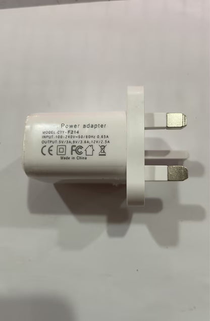 White plastic UK power adapter wall charger with printed technical specifications.