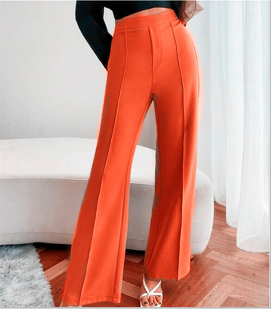 Bright orange high-waist tailored pants with vertical front seams and wide legs.