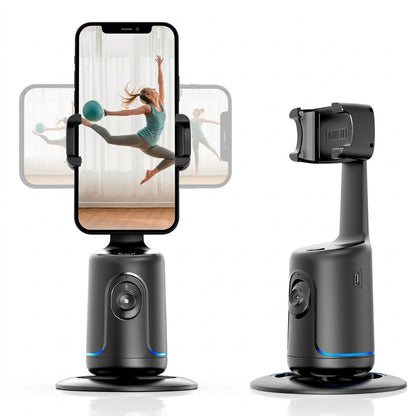 Black motorized phone gimbal with tracking camera and circular base, holding a smartphone showing a dancing woman.
