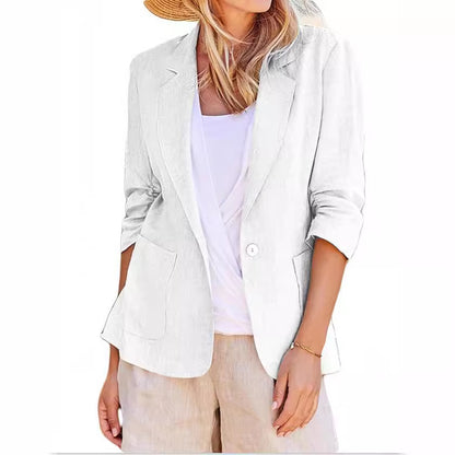 White single-breasted suit jacket with lapels, patch pockets, and three-quarter sleeves worn over a white top.