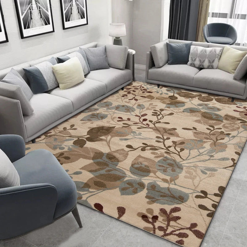 Beige area rug with brown, blue, and cream leaf pattern in a living room.