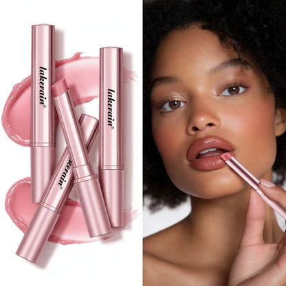 Model applying pink tinted lip balm from a metallic pink tube beside several product tubes.
