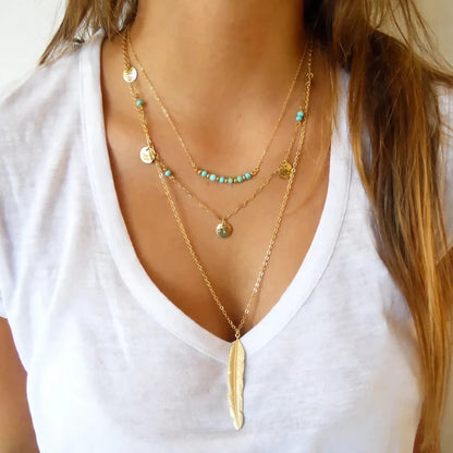 Layered silver chain necklaces with disc and bar pendants