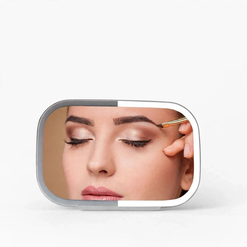 Rectangular LED car visor mirror illuminating a person applying makeup to their eyebrow.