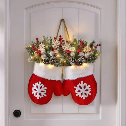 Lighted Christmas mitten wreath with pinecones on a door