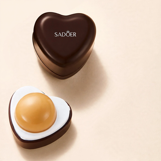 Heart-shaped lip mask container with brown lid and round tan balm inside next to promotional percentages.