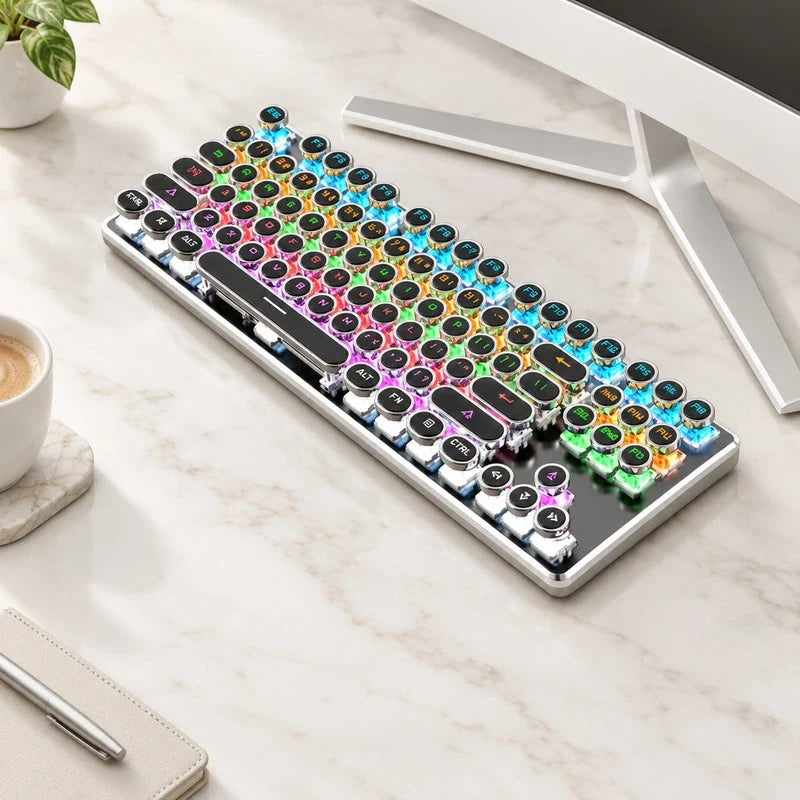 Retro mechanical keyboard with round keys and vibrant RGB backlighting on a marble desk.