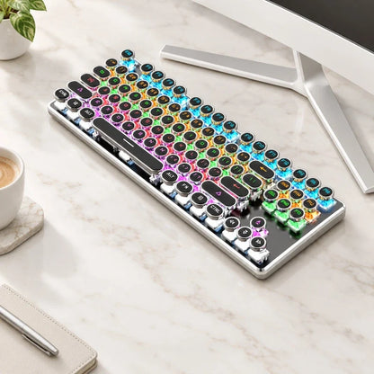 Retro mechanical keyboard with round keys and vibrant RGB backlighting on a marble desk.