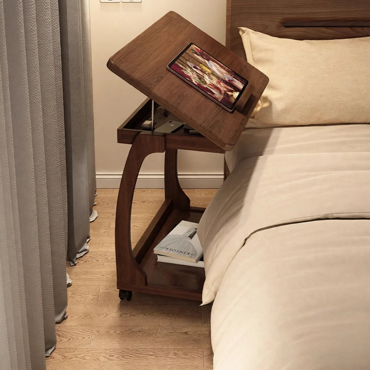 Walnut bedside table with a tilting top holding a tablet, open storage compartment, and lower shelf next to a bed
