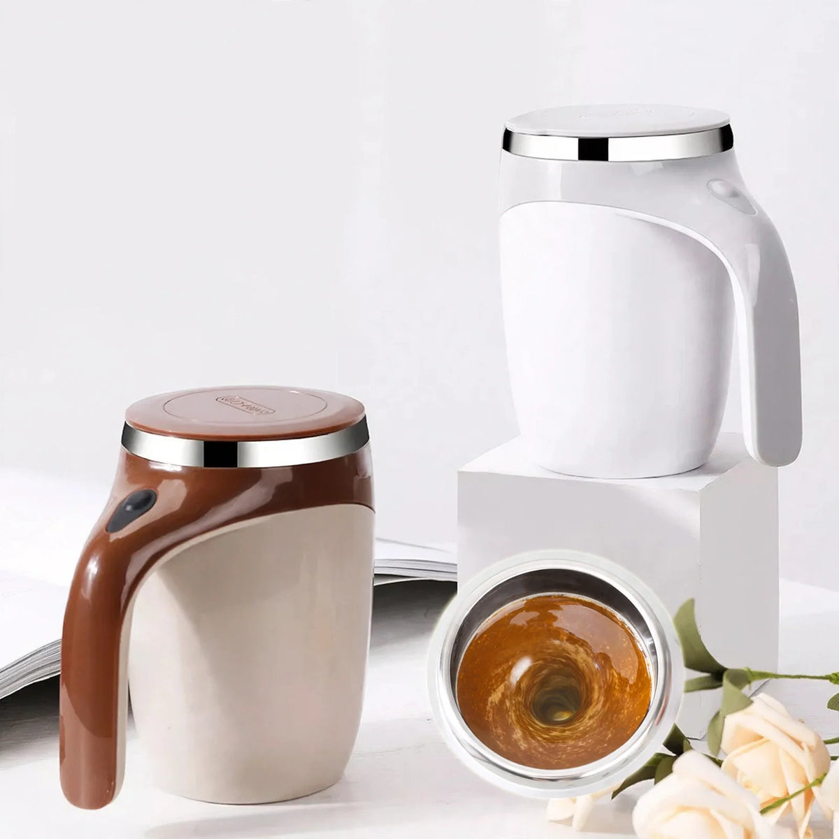 White and brown self-stirring magnetic mugs with liquid swirling inside.