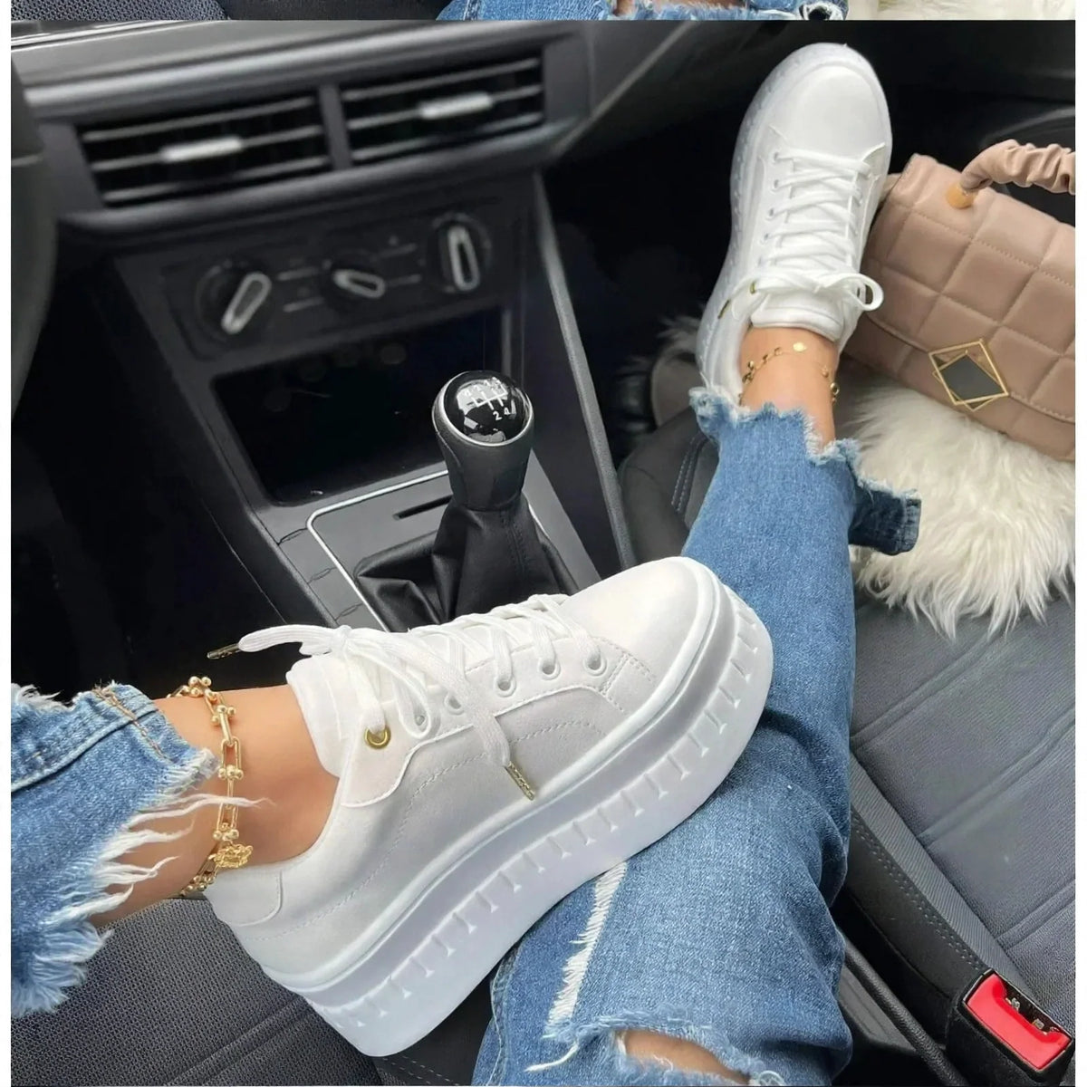Women's white platform sneakers lace-up walking shoes worn in a car